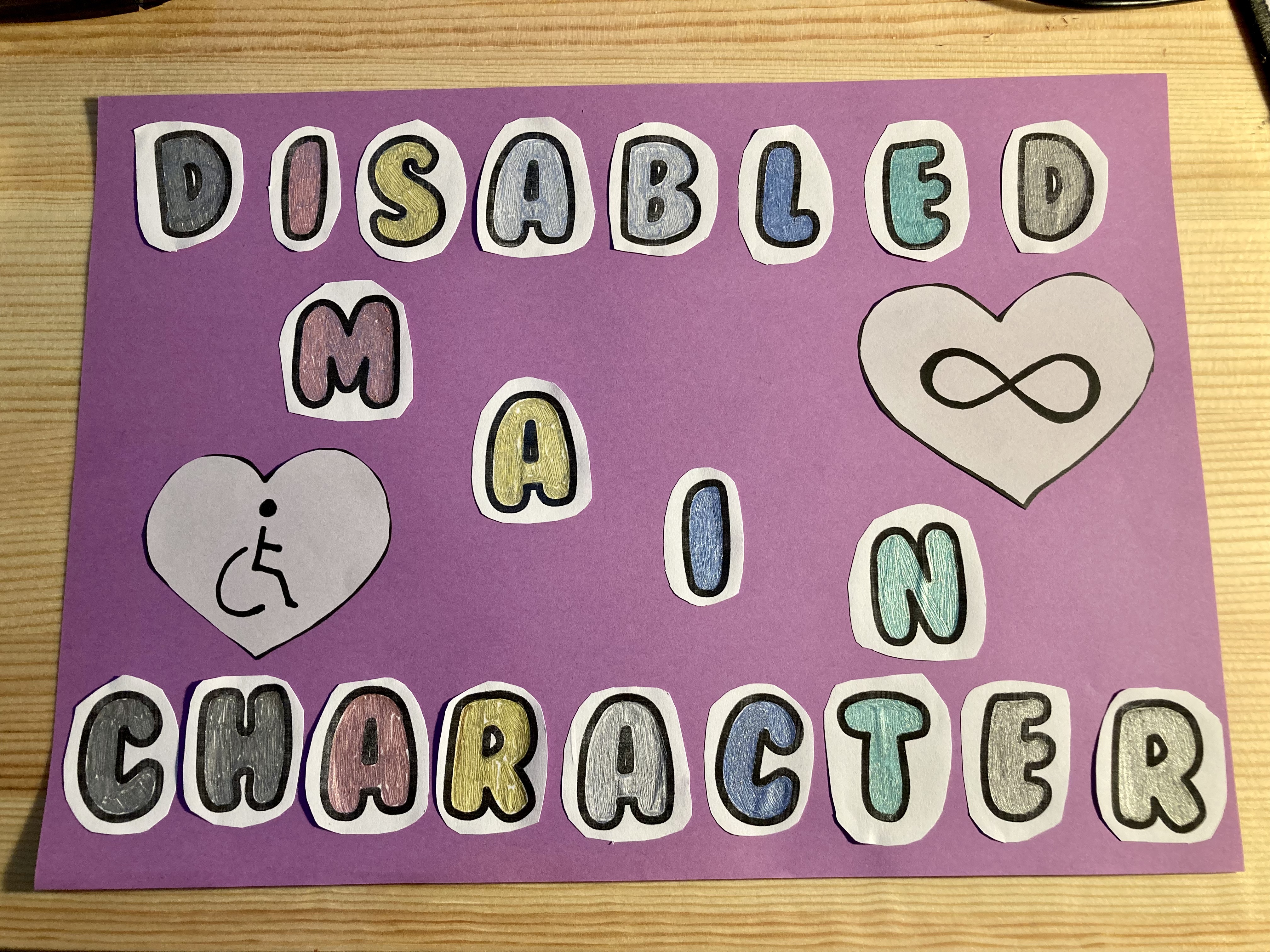 A purple background with the words Disabled Main Character stuck on, along with hearts containing the wheelchair symbol and the infinity symbol.