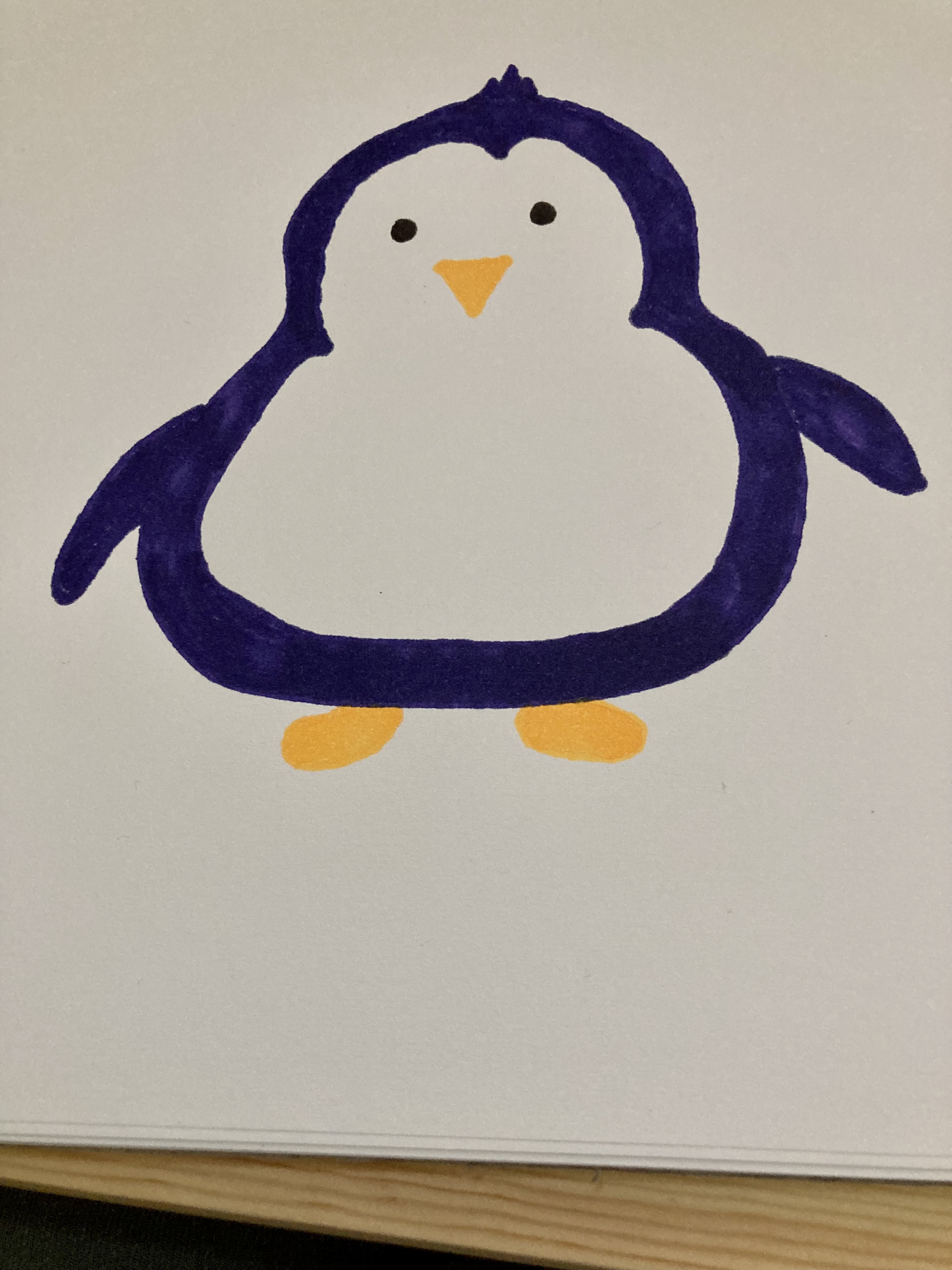 A marker drawing of a catroon penguin.